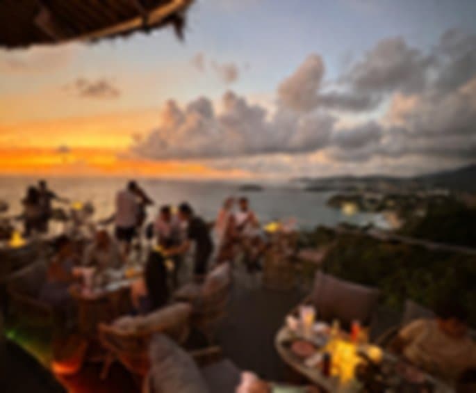 Guests dining on the terrace at sunset